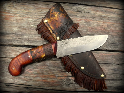frontier pistol grip knife with a decorated rawhide sheath