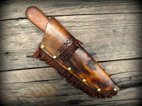 frontier style hunting knife with a rawhide sheath