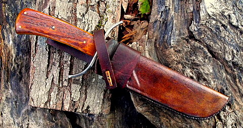 mountain man bowie knife with a leather and rawhide sheath