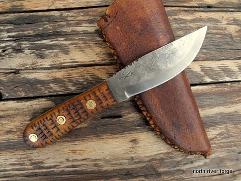 hand forged knife with a deer hide sheath